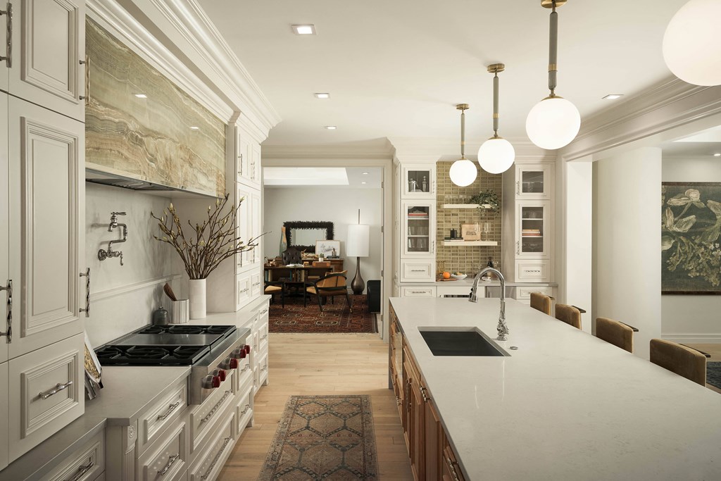 A modern kitchen with a marble backsplash and a large island.