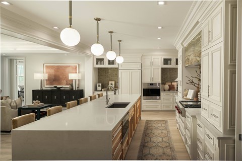 A modern kitchen with a long white island and wooden cabinets.