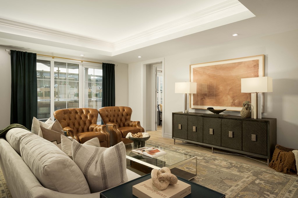 A living room with a brown leather chair and a grey sofa.