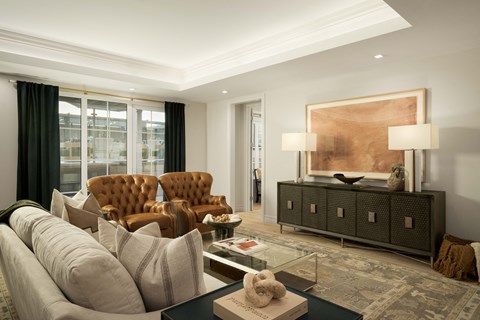 A living room with a brown leather chair and a grey sofa.