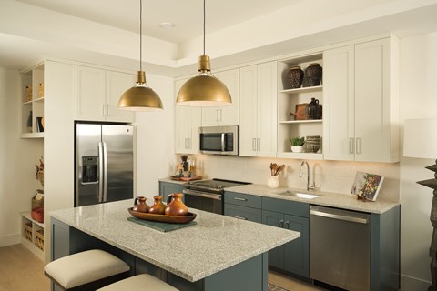 A kitchen with a table and chairs in the middle.