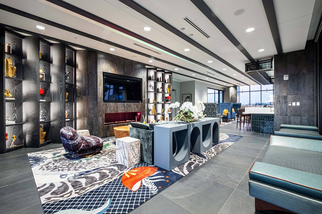 the lobby of a hotel with a reception desk and a tv