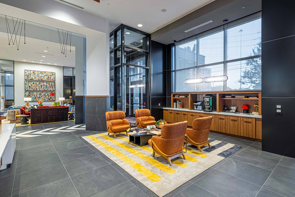 a lobby with chairs and a table and a counter