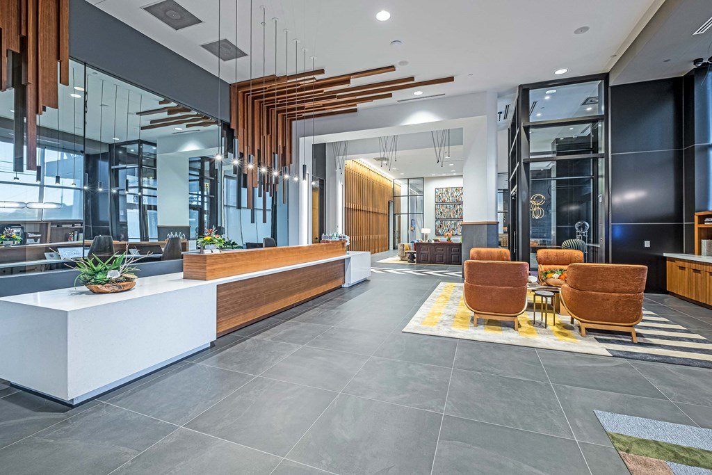 the lobby of a building with chairs and a table