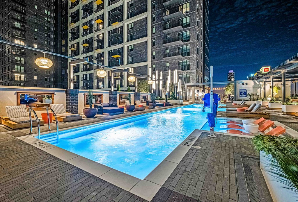 a swimming pool in the middle of a city at night