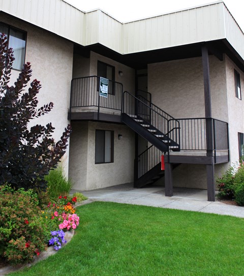 A building with a balcony and stairs.