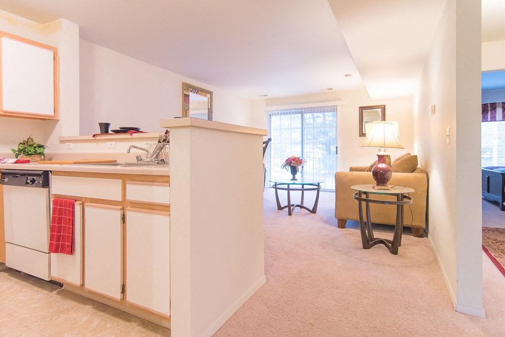 a living room and kitchen with a couch and a table