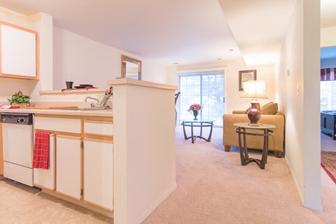 a living room and kitchen with a couch and a table