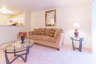 a living room with a couch and a glass table