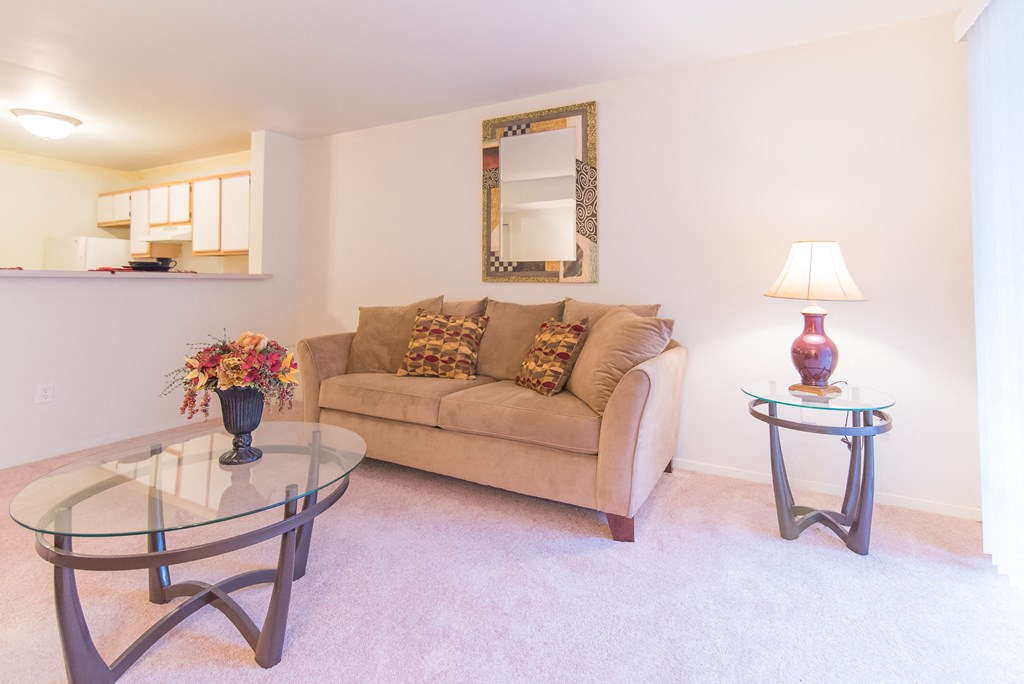 a living room with a couch and a glass table