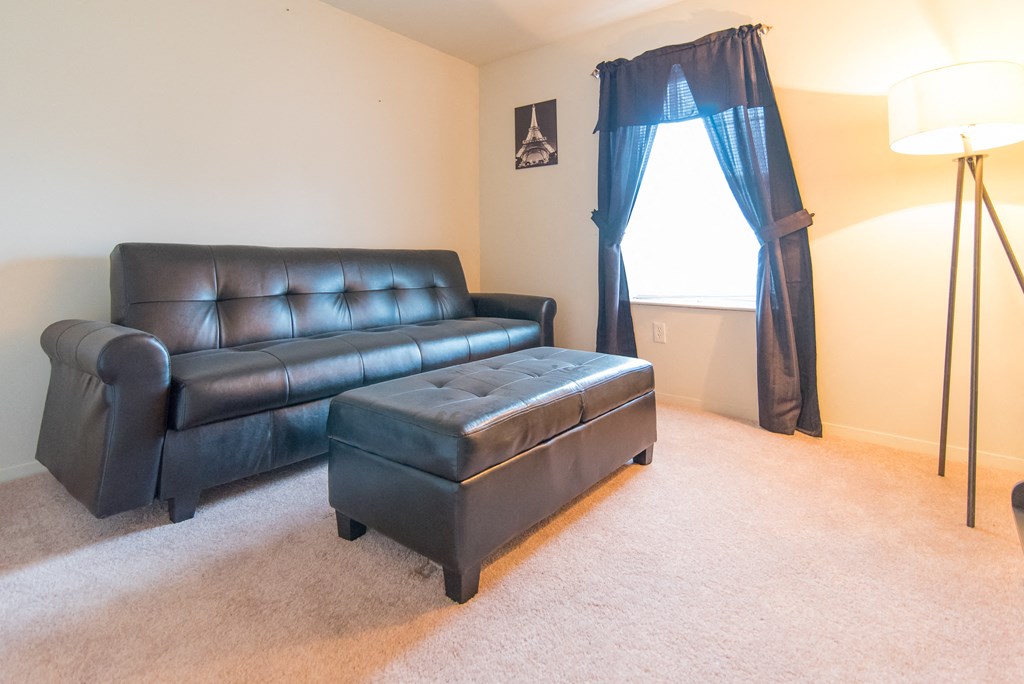 a living room with a leather couch and a