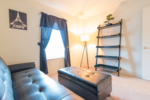 a living room with a leather couch and a