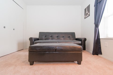 a living room with a leather couch and a