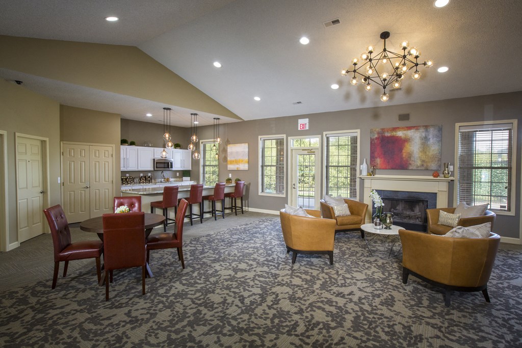 a large living room with a fireplace and a table with chairs