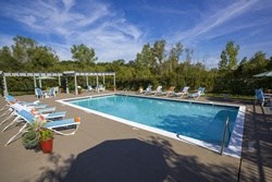 a swimming pool with lounge chairs around it