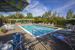 a swimming pool with lounge chairs around it