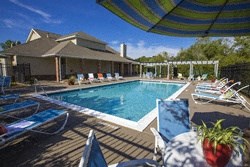 a large swimming pool with lounge chairs around it
