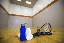 a tennis racket and a water bottle on a tennis court