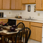 a kitchen and dining room with a table and chairs