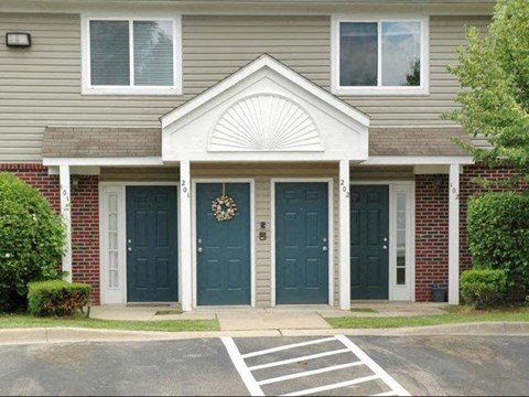 a house with two blue doors and a porch