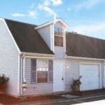 a picture of a white church with a black roof