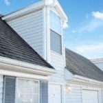 a white house with a window on top of it