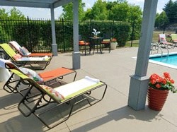 a poolside deck with lounge chairs and a pool