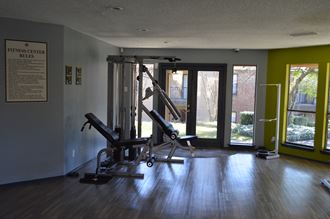 a gym with a exercise bike in the corner of a room