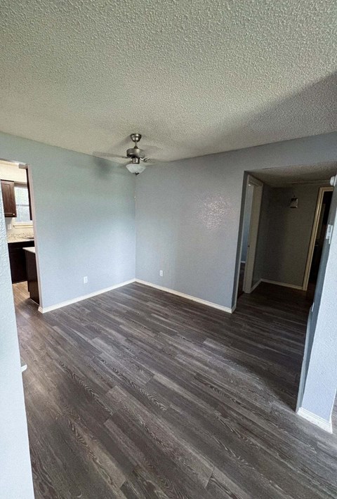 a living room with wood floors and a ceiling fan in Dallas, TX, 75216