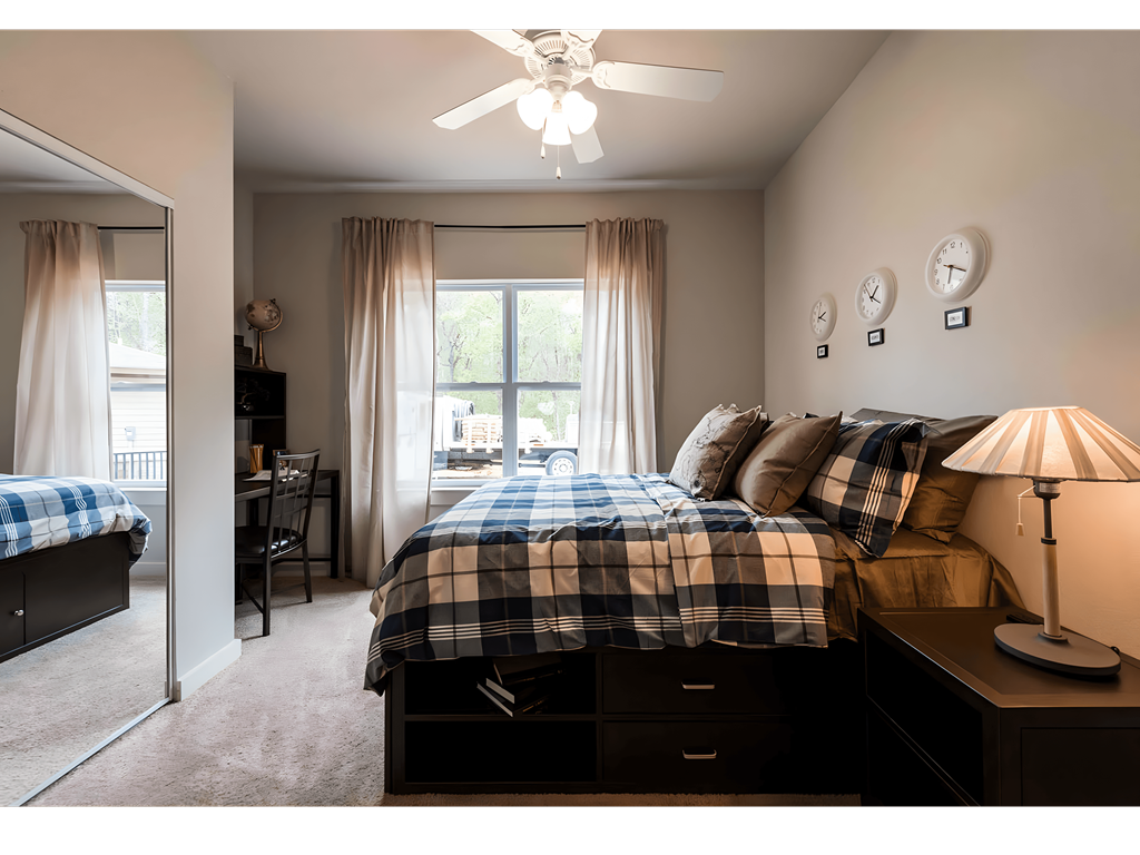 a bedroom with a bed and a ceiling fan