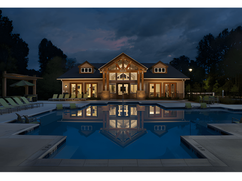 a house with a swimming pool at night