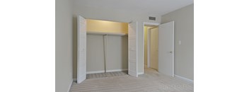 A room with a carpeted floor and a white door.