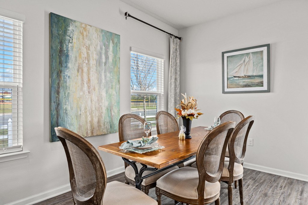 a dining room with a wooden table and chairs