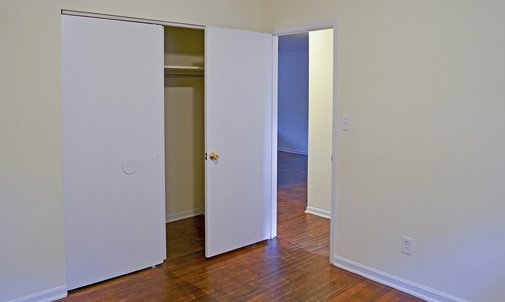 A white door is open to a hallway.