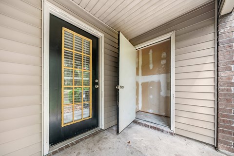 A black door with a window and a white door with a window.