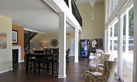 A living room with a fireplace and a dining table.