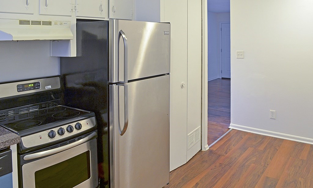 A kitchen with a stove, oven, and refrigerator.