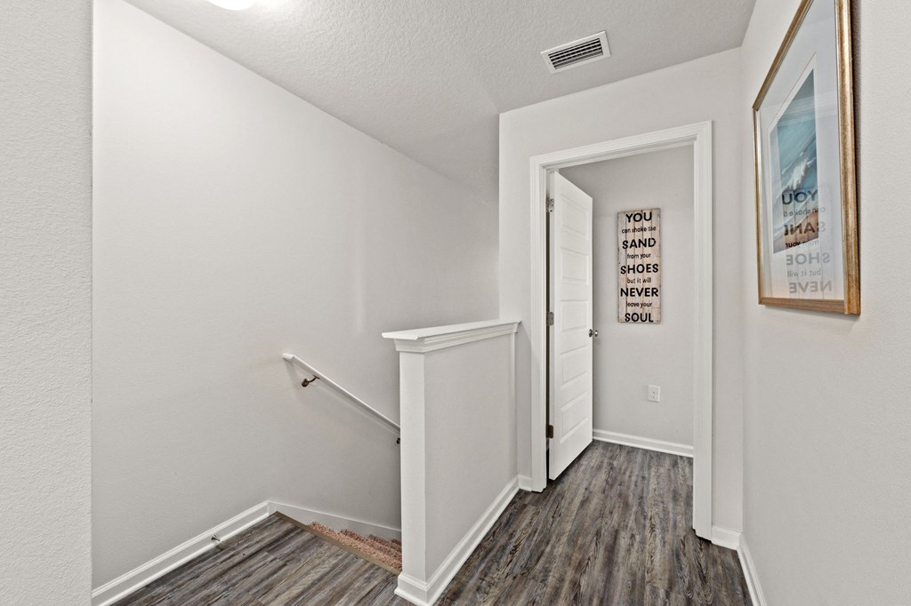 the living room of our studio apartment atrium with white walls and wood flooring
