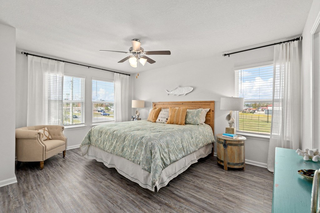 a bedroom with a bed and a ceiling fan