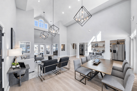 A modern dining room with a large table and chairs.