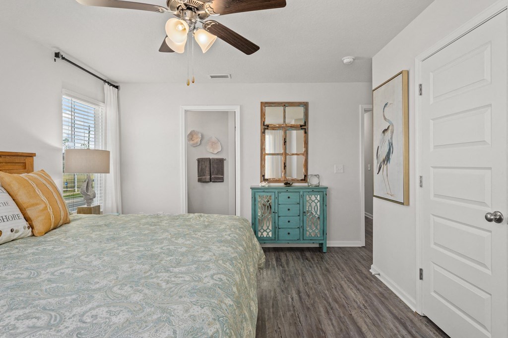 a bedroom with a bed and a ceiling fan