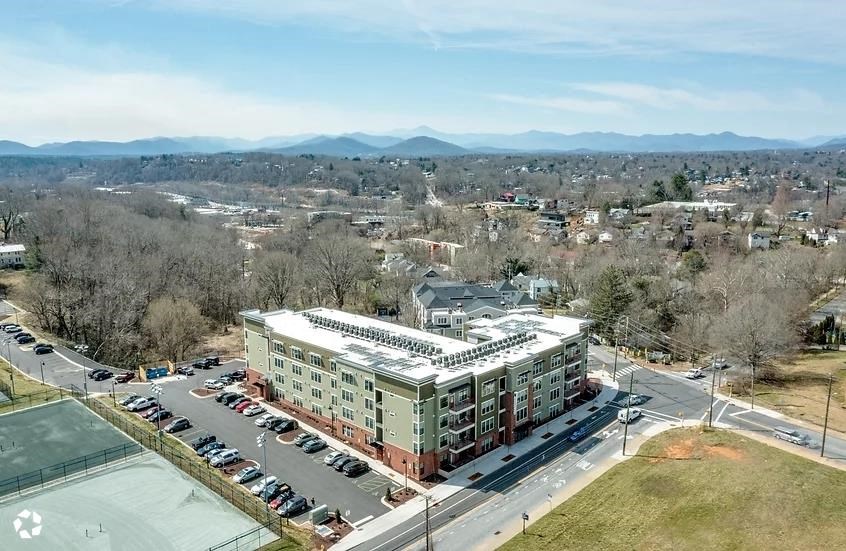 an aerial view of a building and a parking lot