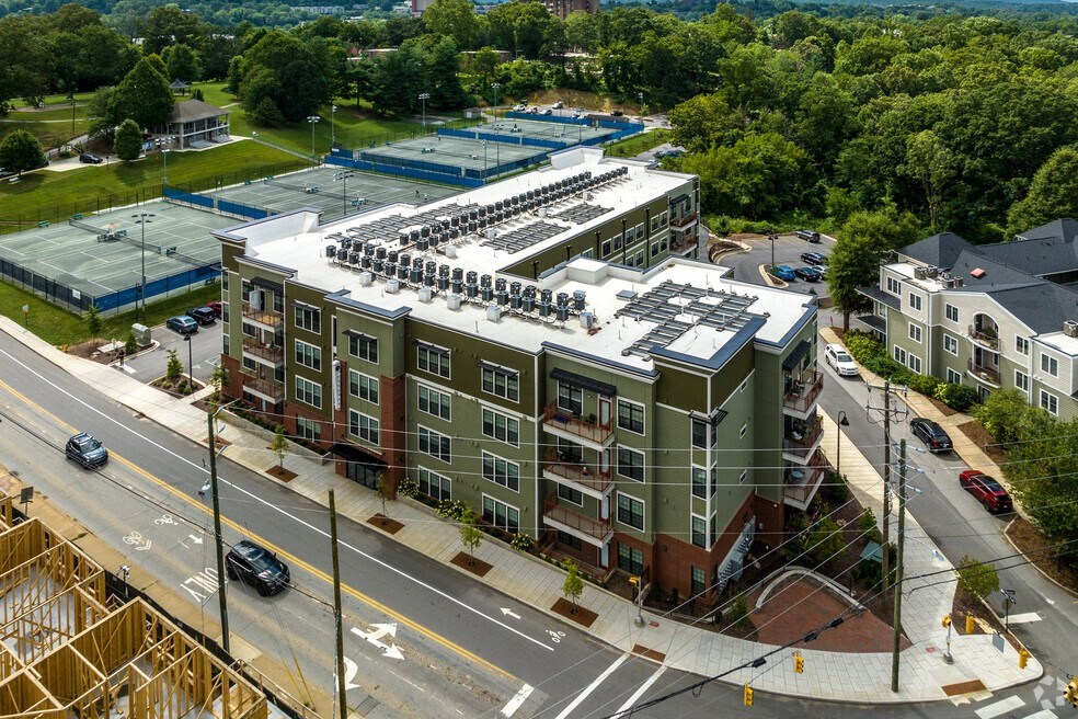 an aerial view of an apartment building with a parking lot