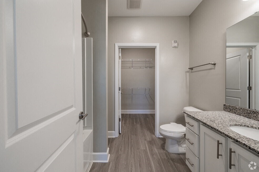 a bathroom with a toilet and a shower and a sink