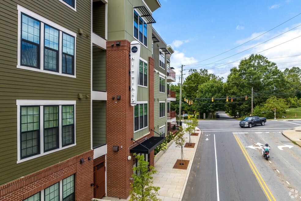 an aerial view of a street with cars driving down it