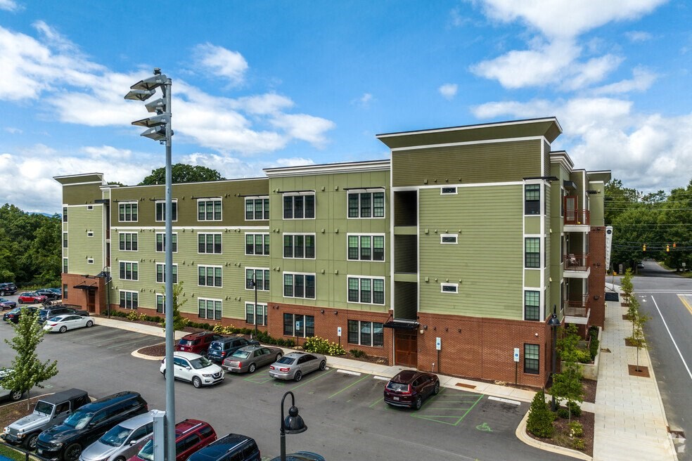 an aerial view of an apartment building with a parking lot