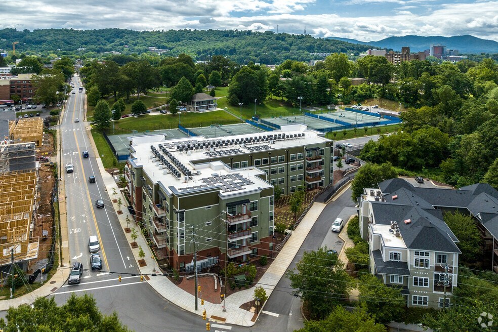 an aerial view of a city with buildings and a parking lot