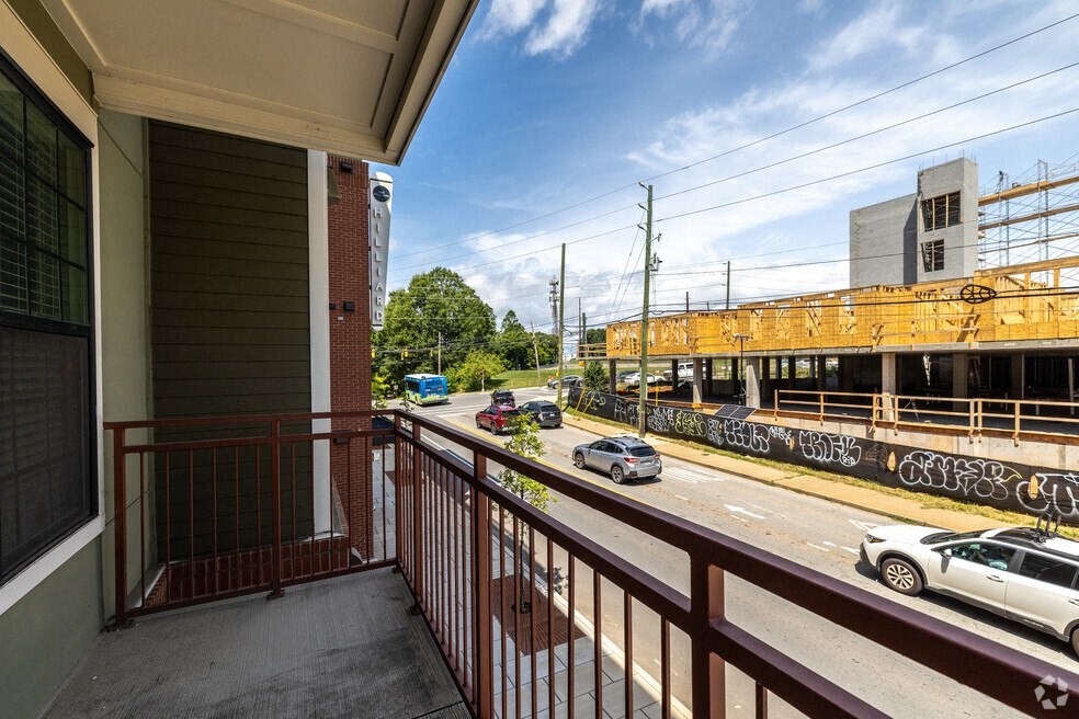 a balcony with a view of a street and a train