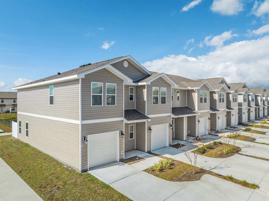 a row of houses in a row on a sidewalk