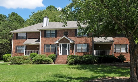 A house with a red brick exterior and a white roof.